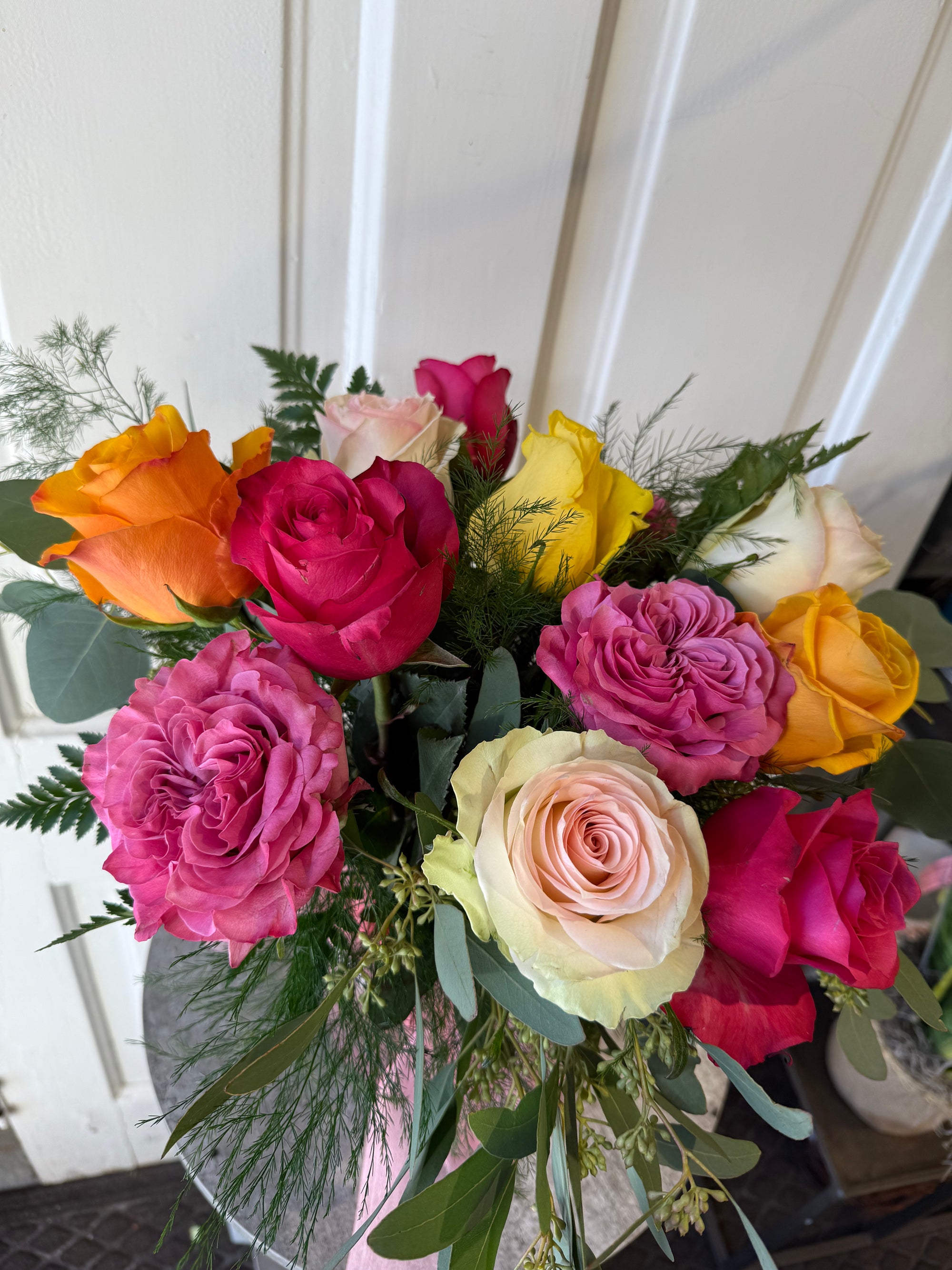 low and lush candy colored dozen roses