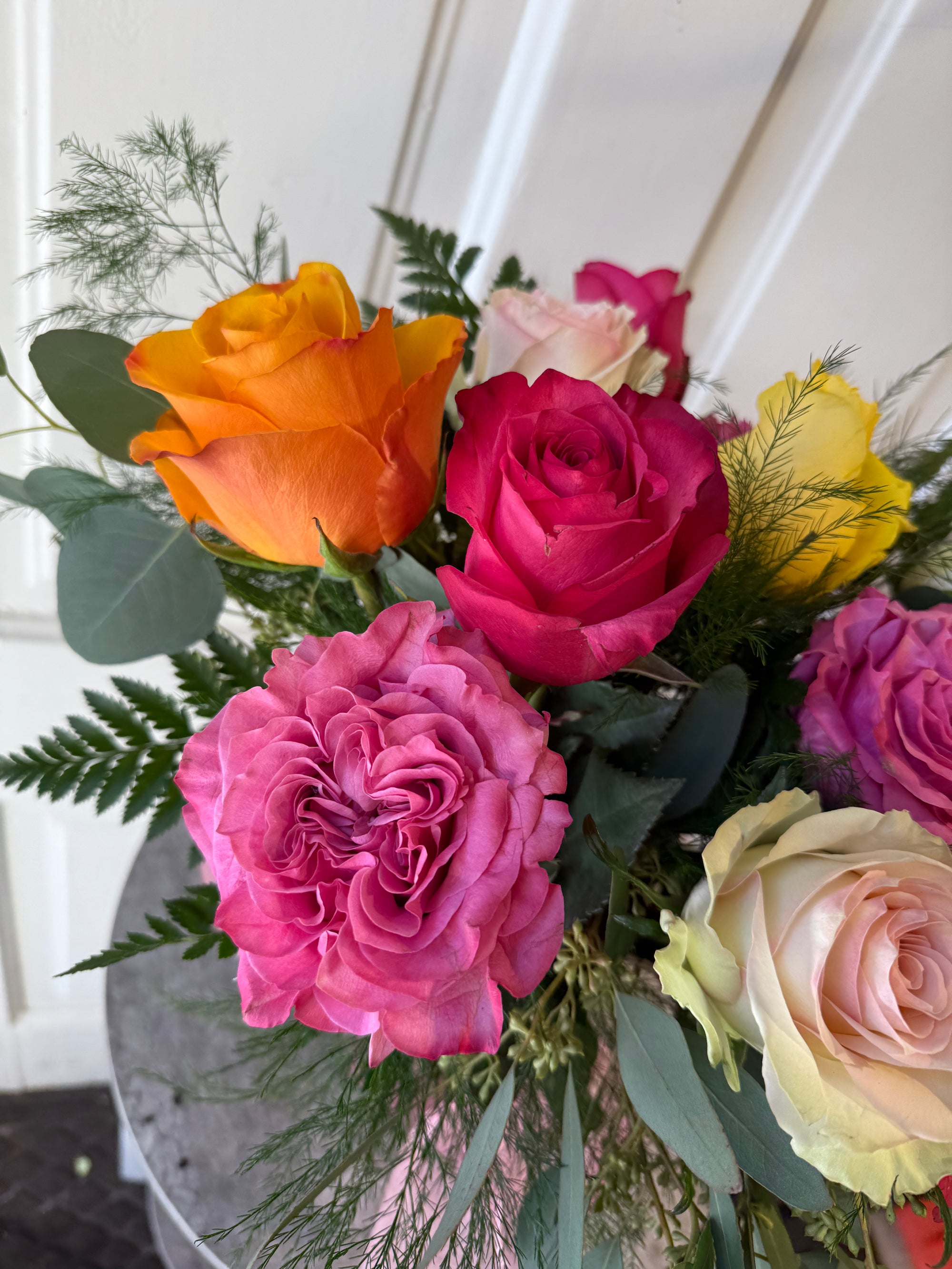 low and lush candy colored dozen roses