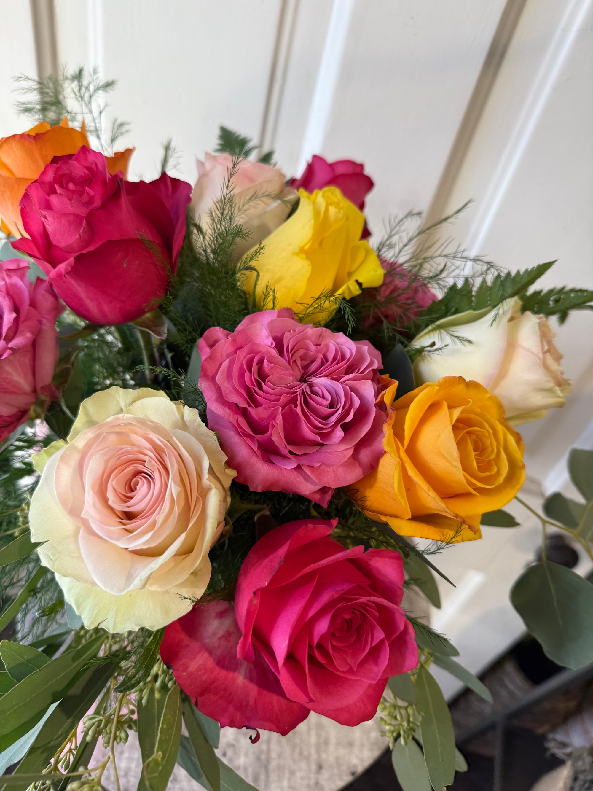 low and lush candy colored dozen roses