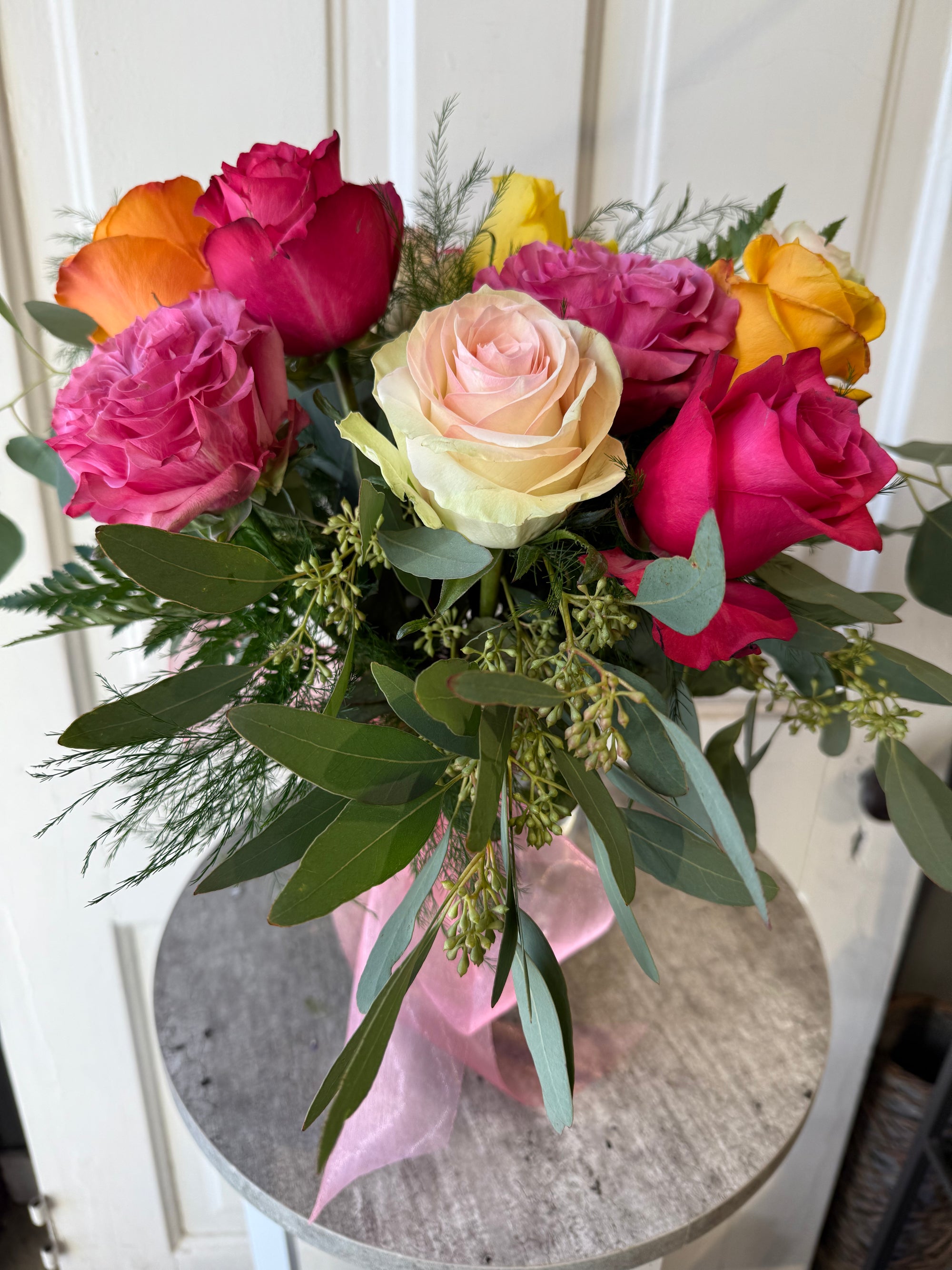 low and lush candy colored dozen roses